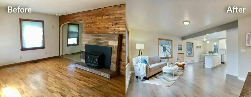 Side-by-side photo of a living room before renovation, with wood paneling and a brick wood stove, and after, opened up with light walls and new flooring